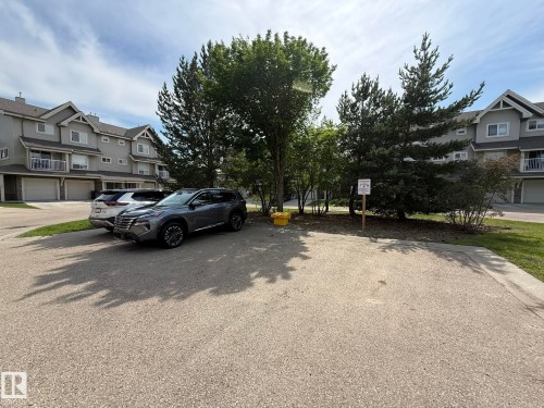 Townhouse complex featuring multiple units, individual garages, and private balconies - #93 12050 17 Av Sw, Edmonton, AB - Outdoor