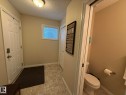 Entryway featuring patterned tile flooring, a white paneled door, and an overhead flush-mount light fixture - #93 12050 17 Av Sw, Edmonton, AB  - Indoor Photo Showing Bathroom 