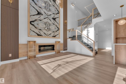 Expansive living area featuring light wood-finish flooring - 382 Linden Loop, Leduc, AB - Indoor With Fireplace