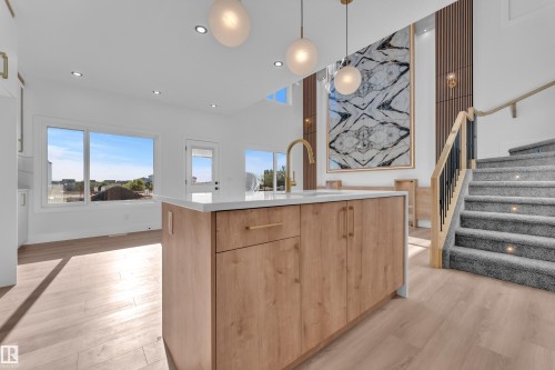 Kitchen island with wood-finish cabinetry and a white countertop - 382 Linden Loop, Leduc, AB - Indoor