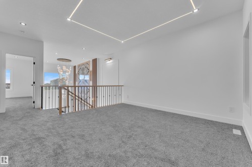 Spacious upper-level landing with plush gray carpeting and recessed ceiling lighting - 382 Linden Loop, Leduc, AB - Indoor Photo Showing Other Room