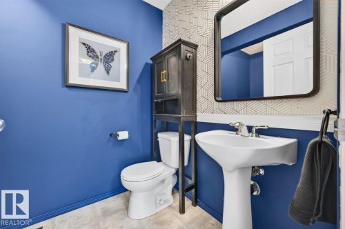 Pedestal sink with chrome faucet, complemented by a wall-mounted mirror - 17411 90 Street Nw, Edmonton, AB - Indoor Photo Showing Bathroom