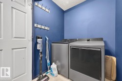 Dedicated laundry area featuring a front-loading washer and dryer set - 