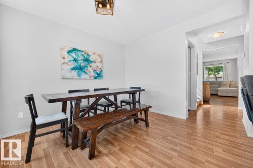 Dining area featuring light wood-finish flooring, white walls, and a contemporary ceiling light fixture - 17411 90 Street Nw, Edmonton, AB - Indoor Photo Showing Dining Room