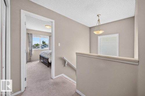Upper-level hallway with neutral wall paint and carpet flooring - 17411 90 Street Nw, Edmonton, AB - Indoor Photo Showing Other Room