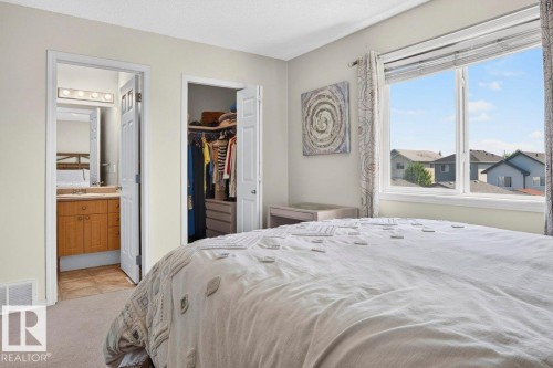 Carpeted room with a large window, providing natural light - 17411 90 Street Nw, Edmonton, AB - Indoor Photo Showing Bedroom