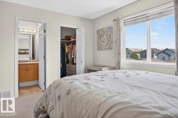 Carpeted room with a large window, providing natural light - 