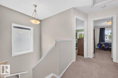 Upper-level hallway featuring neutral-toned walls, recessed lighting, and a pendant light fixture - 17411 90 Street Nw, Edmonton, AB - Indoor Photo Showing Other Room