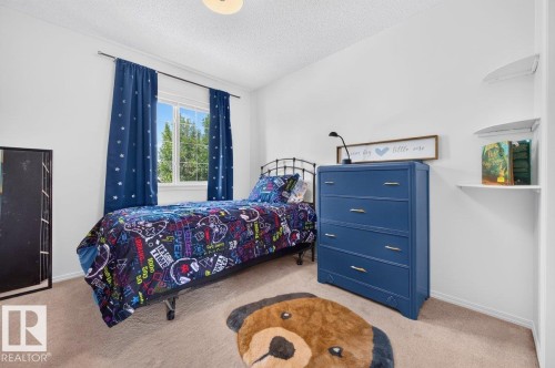 Bright bedroom featuring neutral carpet flooring and white walls - 17411 90 Street Nw, Edmonton, AB - Indoor Photo Showing Bedroom