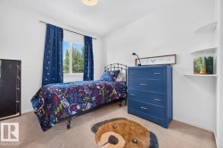 Bright bedroom featuring neutral carpet flooring and white walls - 