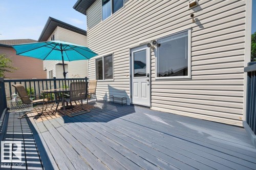 Spacious outdoor deck with a gray wood-finish surface and dark railing - 17411 90 Street Nw, Edmonton, AB - Outdoor With Deck Patio Veranda With Exterior