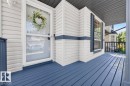 Inviting front porch featuring blue-painted wood decking, white siding, and a white storm door - 17411 90 Street Nw, Edmonton, AB  - Outdoor With Deck Patio Veranda With Exterior 