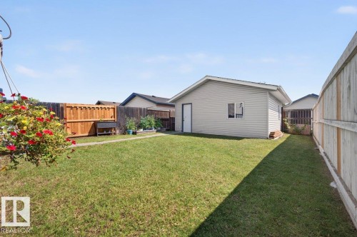 Detached garage with light-colored siding, a single window, and a service door - 17411 90 Street Nw, Edmonton, AB - Outdoor With Exterior