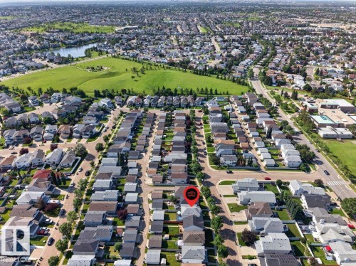 Residential neighborhood featuring established trees and a large green space with a prominent pond - 17411 90 Street Nw, Edmonton, AB - Outdoor With View
