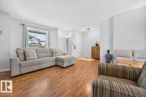 Bright living space featuring wood-finish flooring and a front entryway - 17411 90 Street Nw, Edmonton, AB - Indoor Photo Showing Living Room