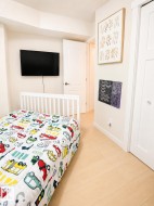 Neutral wall finishes complement the light wood-finish flooring - 