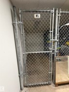 Chain-link storage enclosure with galvanized steel framing and a dedicated identifier - 