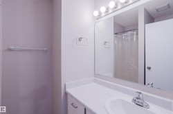 Bathroom vanity featuring a white countertop, integrated sink, and chrome faucet - 