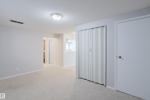 Bright interior space featuring light-colored walls and patterned carpeting - 337 Pearson Crescent Nw, Edmonton, AB - Indoor Photo Showing Other Room