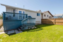 Expansive backyard featuring a manicured lawn and a privacy fence - 