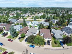 Suburban residential landscape featuring a variety of single-family homes with pitched roofs and attached garages - 