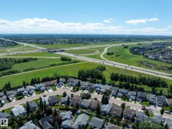 Aerial perspective showcasing a residential area with a network of roadways and green spaces - 