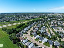 Expansive residential neighborhood featuring single-family homes with pitched roofs and mature landscaping - 