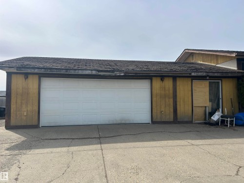 Two-car garage with a paneled white door - 15020 116 Street, Edmonton, AB - Outdoor