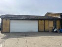 Two-car garage with a paneled white door - 15020 116 Street, Edmonton, AB  - Outdoor 