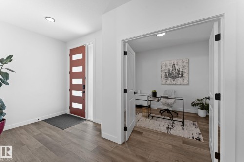 Entryway featuring wood-finish flooring, a contemporary front door with horizontal lites, and a recessed ceiling light - 59 Willow Link, Fort Saskatchewan, AB - Indoor Photo Showing Other Room