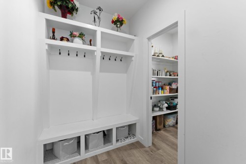 Built-in white storage unit featuring shelving, coat hooks, and bench seating with cubbies - 59 Willow Link, Fort Saskatchewan, AB - Indoor Photo Showing Other Room