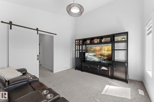 Spacious room featuring a vaulted ceiling and light gray carpeting - 59 Willow Link, Fort Saskatchewan, AB - Indoor