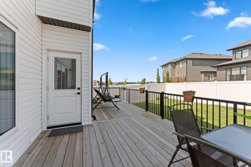 Spacious wood-finish deck with black metal railings - 59 Willow Link, Fort Saskatchewan, AB - Outdoor With Deck Patio Veranda With Exterior
