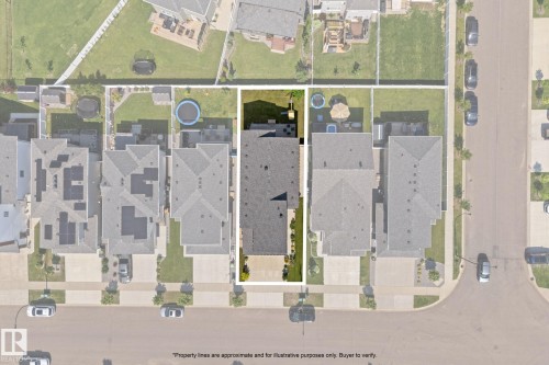 Aerial view showcasing the property's rectangular lot with a dark-pitched roofline, a manicured lawn, and a paved driveway - 59 Willow Link, Fort Saskatchewan, AB - Other