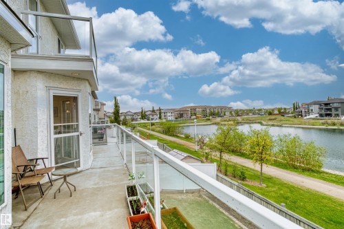Private balcony with durable concrete flooring and a glass railing system - 7622 168A Avenue, Edmonton, AB - Outdoor With Body Of Water With Balcony With View