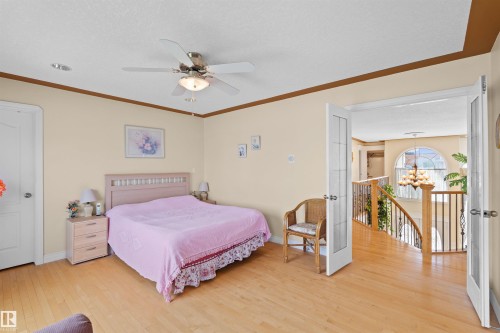 Hardwood-style flooring throughout, featuring a ceiling fan with integrated lighting and recessed ceiling lights - 7622 168A Avenue, Edmonton, AB - Indoor Photo Showing Bedroom