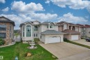 Two-story stucco exterior featuring a tiered fountain, arched and bay windows, a two-car garage, and an extended driveway - 7622 168A Avenue, Edmonton, AB  - Outdoor With Facade 