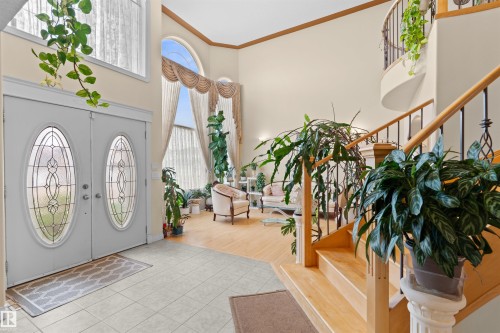 Grand foyer with double entry doors featuring leaded glass inserts - 7622 168A Avenue, Edmonton, AB - Indoor Photo Showing Other Room