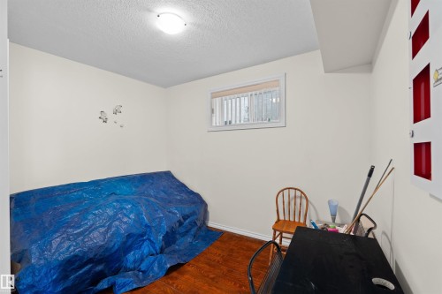Room featuring wood-finish flooring, a single window with blinds, and recessed ceiling lighting - 7622 168A Avenue, Edmonton, AB - Indoor Photo Showing Bedroom