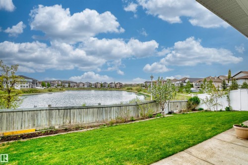 Expansive backyard with a manicured lawn, concrete patio, and a wood fence - 7622 168A Avenue, Edmonton, AB - Outdoor With View