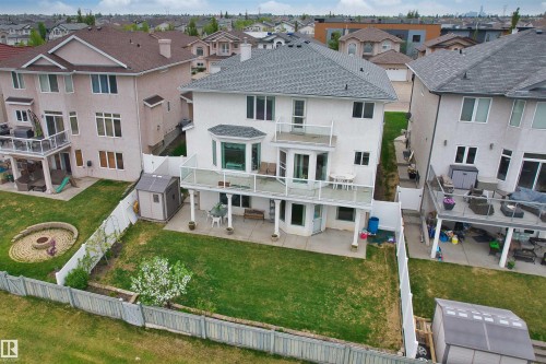 Rear exterior of a two-story residence featuring a gray shingle roof and stucco siding - 7622 168A Avenue, Edmonton, AB - Outdoor