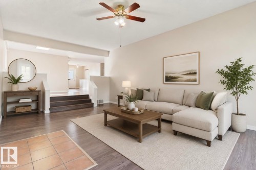 Spacious living area featuring a ceiling fan, recessed lighting, wood-finish flooring, and a multi-level layout with stairs - 10211 95 Ave, Morinville, AB - Indoor Photo Showing Living Room