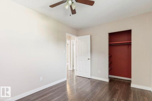 Interior room featuring wood-finish flooring and light-toned walls - 10211 95 Ave, Morinville, AB - Indoor Photo Showing Other Room