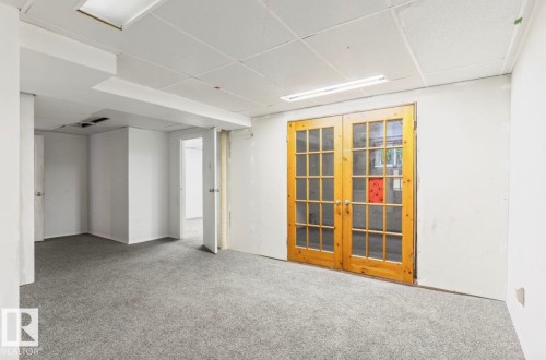 Spacious interior room featuring light gray carpeting and white walls - 10211 95 Ave, Morinville, AB - Indoor