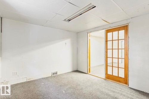 Interior space with light gray carpet flooring, white walls, and a drop ceiling - 10211 95 Ave, Morinville, AB - Indoor Photo Showing Other Room