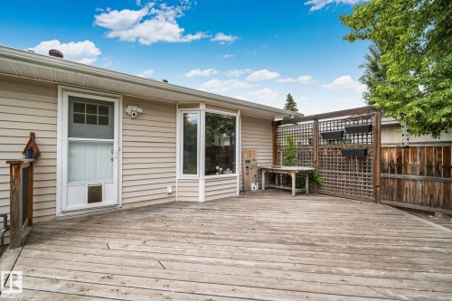 Expansive outdoor deck featuring wood flooring and a privacy trellis - 7306 21 Avenue Nw, Edmonton, AB - Outdoor With Exterior
