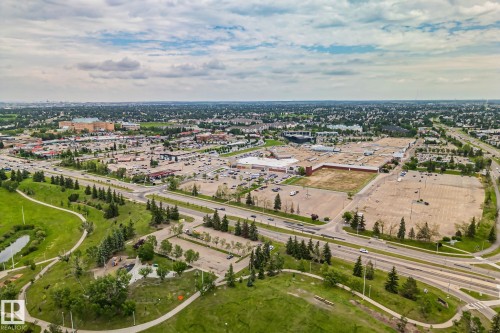 Expansive aerial showcasing a retail district with multiple commercial structures and extensive paved parking areas - 7306 21 Avenue Nw, Edmonton, AB - Outdoor With View