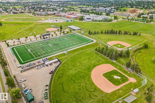 Extensive recreational grounds featuring multiple sports fields including a full-sized artificial turf football field, two baseball diamonds, and a running track - 7306 21 Avenue Nw, Edmonton, AB - Outdoor With View