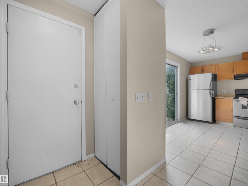 Entryway featuring a white door, adjacent closet, and light-toned tile flooring - 3509 43A Avenue Nw, Edmonton, AB - Indoor Photo Showing Kitchen