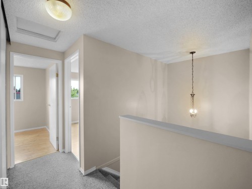 Upper-level landing featuring neutral paint, gray carpet, and white trim - 3509 43A Avenue Nw, Edmonton, AB - Indoor Photo Showing Other Room